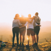 image of four people looking into the sunset